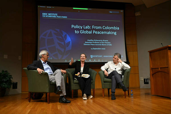 Josefina Echavarria Alvarez speaking at a lecture with Juan Manual Santos and John Paul Lederach.